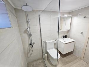 a bathroom with a shower and a toilet and a sink at Casa Nevina in Marathokampos +25 photos