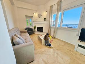 two children playing in a living room with a couch at Casa Nevina in Marathokampos