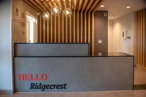 a reception desk in a lobby with a hello rippost sign at TownePlace Suites by Marriott Ridgecrest in Ridgecrest +25 photos