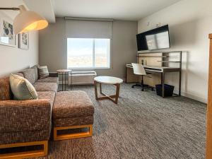 a living room with a couch and a desk at TownePlace Suites by Marriott Ridgecrest in Ridgecrest