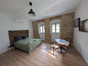a bedroom with a bed and a table in it at Maison Bátori Tarczal in Tarcal