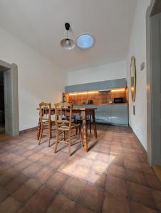 a dining room with a table and chairs on a tile floor at Maison Bátori Tarczal in Tarcal