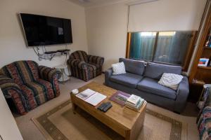 a living room with a couch and a coffee table at Flinders Ranges Bed and Breakfast in Hawker