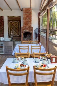 a dining room with a table and chairs and a fireplace at April Mansion in Istanbul
