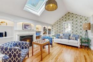a living room with a couch and chairs and a fireplace at Tideview Estate in Cumberland Foreside