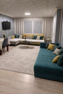 a living room with a couch and a tv at Vila city in Bijeljina