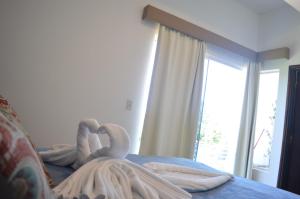 Ένα ή περισσότερα κρεβάτια σε δωμάτιο στο Hotel Puesta del Sol by Nobile