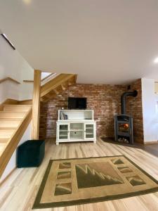 a living room with stairs and a fireplace at Mazurski Dom Rodzinny in Pisz