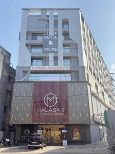 a building with a sign on the front of it at Hotel Yagnik Inn in Rajkot