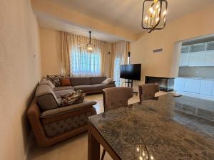 a living room with a couch and a table at Villa in Čeluga