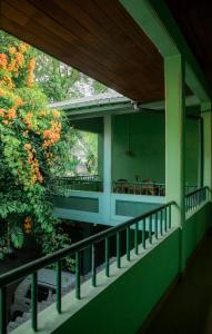 a balcony of a house with a tree at Pavani Villa Kandy in Peradeniya