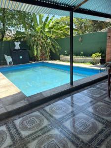 a swimming pool in a backyard with a tile floor and a swimming pool at challet1 in Yerba Buena