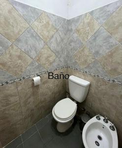 a bathroom with a white toilet and a sink at challet1 in Yerba Buena