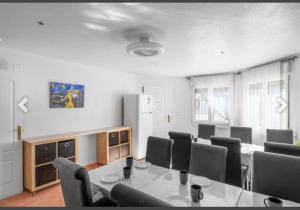 a conference room with a table and chairs and a refrigerator at Casa Lanjaron in San Miguel de Salinas