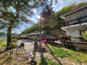 a house with flowers on the side of it at Hongcheon Riverhill Stay in Hongcheon +32 photos