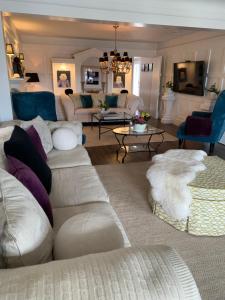 a living room with white couches and a couch at 33 On Gage Garden Suite in Niagara-on-the-Lake