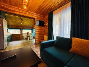 a living room with a couch and a table at Уютный Деревянный дом в Кикети in Kiketʼi