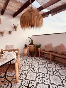 a living room with benches and a table at Raíces de Canillas Holiday Apartments in Canillas de Aceituno