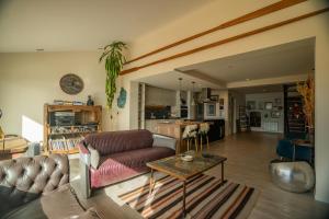 a living room with a couch and a table at MINI LOFT Departamentos Bariloche in San Carlos de Bariloche