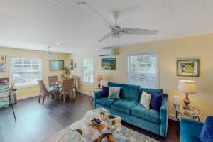a living room with a blue couch and a table at Andros Suite in Key West