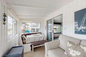 a white bedroom with a bed and a couch at Wishing Wells in Wells