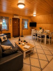 a living room with a couch and a table at Domki Bieszczady Siedlisko Harenda in Czarna