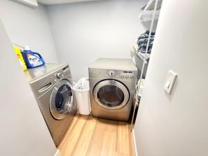 a washer and dryer in a small laundry room at 2 bedroom Cozy Secondary-Basement suite in Calgary