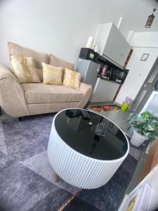 a living room with a couch and a coffee table at CozMila homes in Kiambu