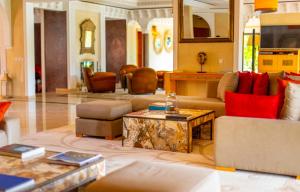 a living room with couches and a coffee table at Mila Dyafa in Oulad Akkou