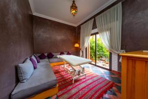 a living room with a couch and a table at Mila Dyafa in Oulad Akkou +55 photos
