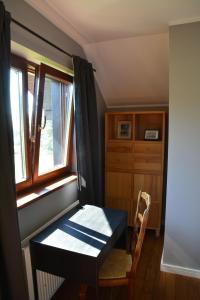 a small room with a desk and a window at Leśna 6 - House with a garden in Bolechowice