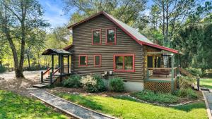 a small wooden house with a red roof at A Rivers Edge in Mineral Bluff