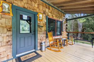 a front door of a house with chairs and a table at A Rivers Edge in Mineral Bluff +49 photos