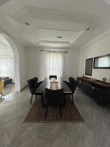 a living room with a dining table and chairs at Fawis Lodge in Brusubi +8 photos