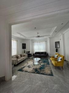 a living room with couches and a coffee table at Fawis Lodge in Brusubi