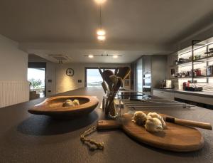 a kitchen with a wooden cutting board and a bowl of garlic at Astraea Villa in Karistos