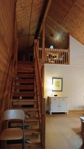 a wooden staircase in a room with a desk at Quinta de Argos in Cehegín