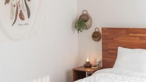 a bedroom with a bed and a table with a candle at Yangyang Stay Wabom in Yangyang
