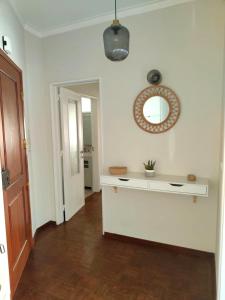 a white room with a table and a mirror on the wall at Lx Factory Apartment-Lisbon Style-Spacious & Bright-Congress Centre in Lisbon +5 photos