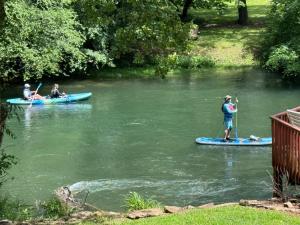 a group of people on kayaks on a river at Bigfoots River Retreat in Mineral Bluff