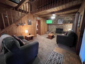 a living room with two couches and a television at Bigfoots River Retreat in Mineral Bluff +28 photos