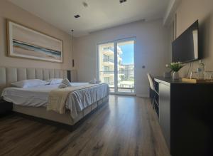 a bedroom with a bed and a large window at Uma Premium in Ulcinj