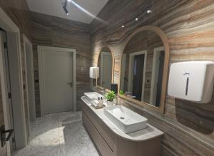 a bathroom with two sinks and a large mirror at Uma Premium in Ulcinj +28 photos