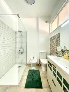 a bathroom with a shower and a toilet and a sink at Lx Factory Apartment-Lisbon Style-Spacious & Bright-Congress Centre in Lisbon