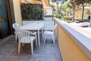 a patio with a table and chairs on a balcony at IL TRITONE in Marina di Bibbona +58 photos