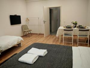 a living room with a table and a dining room at Chez Alice 1 in Montbéliard