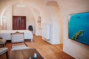 a room with a bed and an aquarium on the wall at genius loci apartments in Levoča