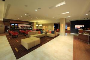 a lobby of a hotel with couches and a bar at Courtyard Biloxi North/D'Iberville in Biloxi