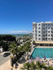 a view of a hotel with a pool and a building at Golem Apartments in Golem