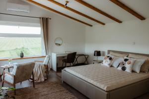 a bedroom with a bed and a desk and a window at Vinewood in Grabrovnik +44 photos